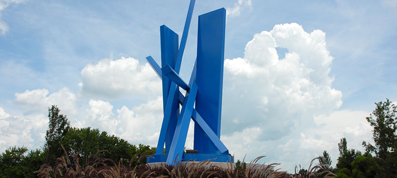 Sculpture by John Henry sit at the entrance to main campus