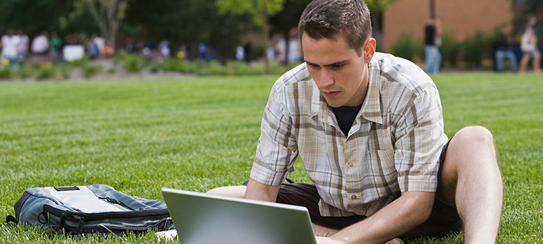 Student studying outside with laptop
